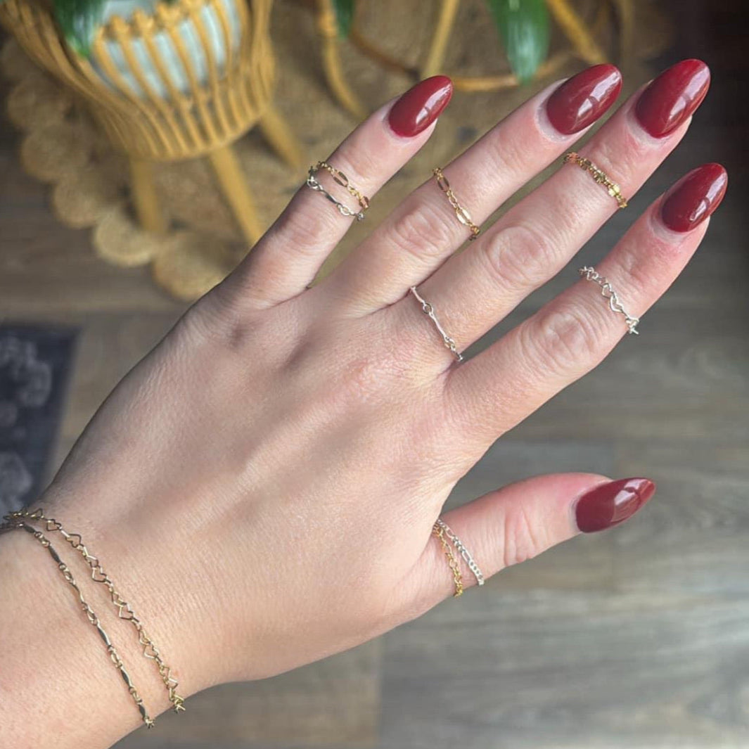 Permanent jewelry rings on hand